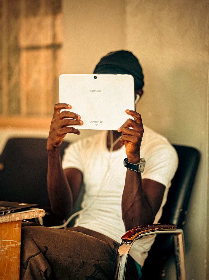A young man watching a video on a tablet